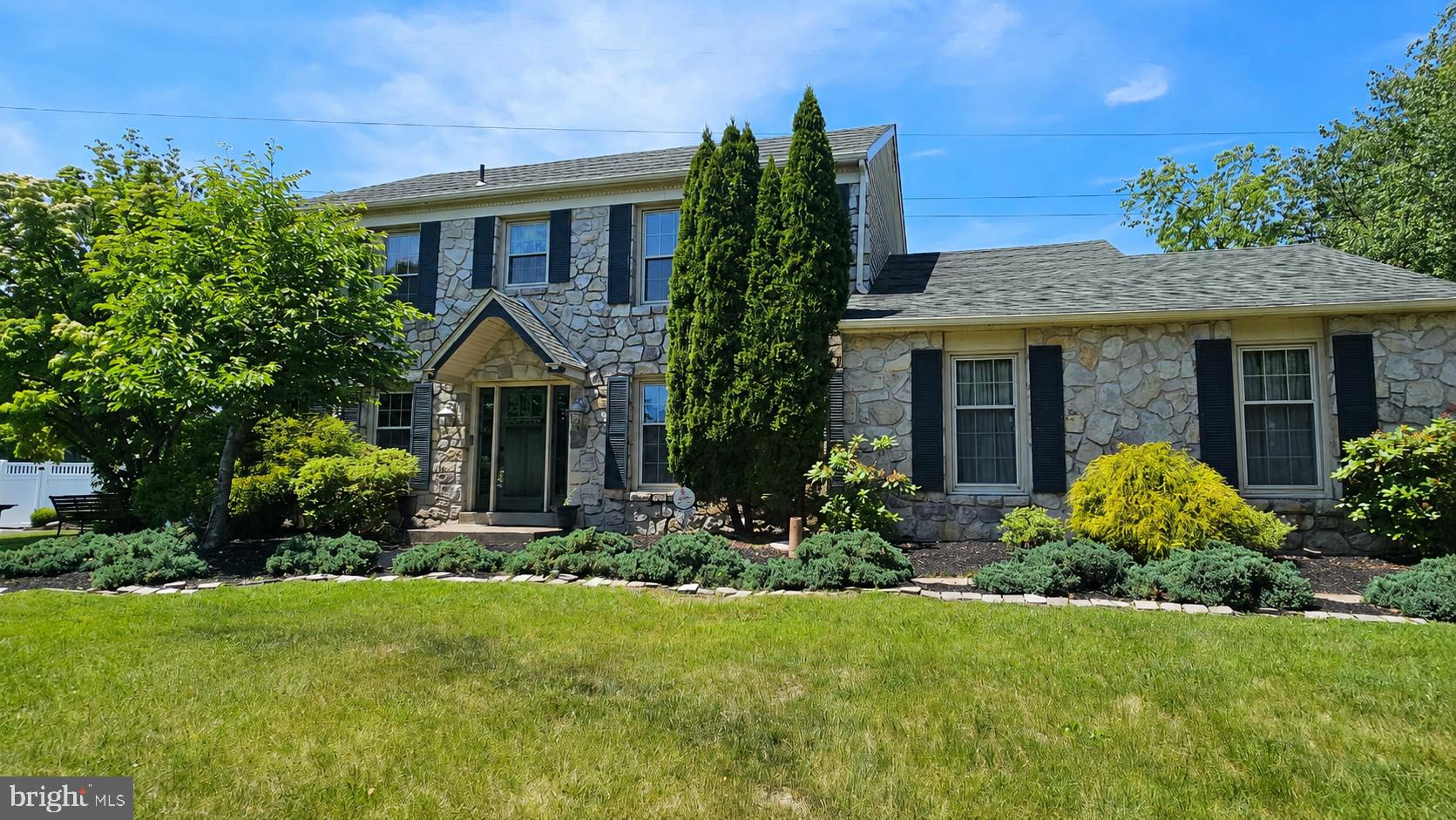 21 Winthrop Road Lawrenceville, NJ 08648 - Photo 1 of 1 Charming stone facade with lush greenery.