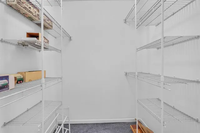 a view of storage and utility room with racks on the wall