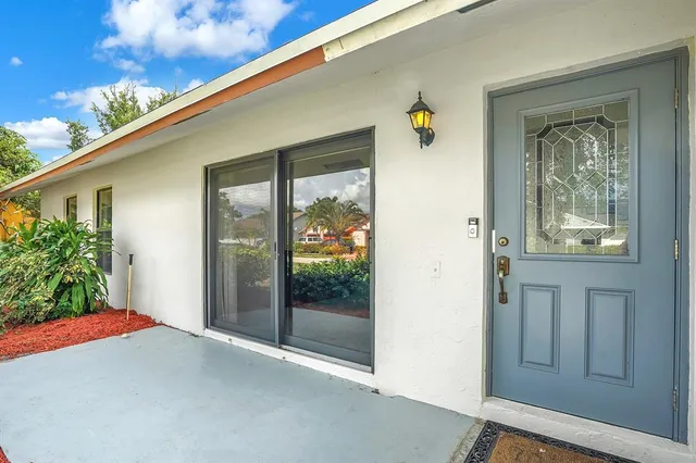 a backyard of a house with wooden floor and outdoor space