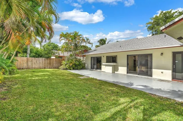 a front view of a house with a garden and yard
