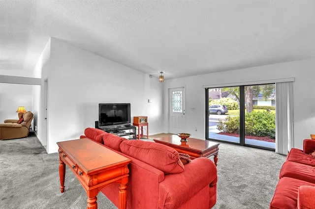 a bedroom with furniture and a flat screen tv