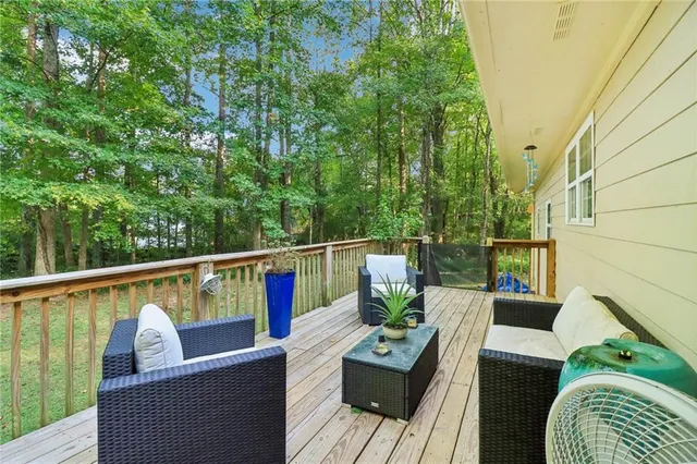 a view of balcony with furniture and wooden deck