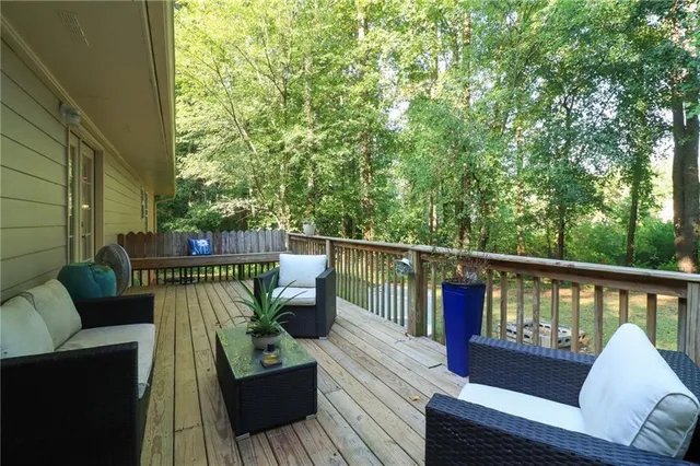 a view of a deck with couches and wooden floor