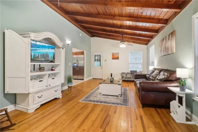 a living room with furniture and wooden floors