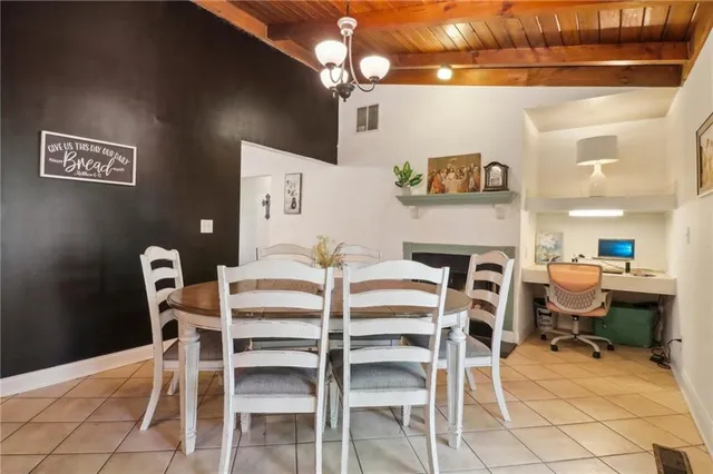 a view of a dining room with furniture and chandelier
