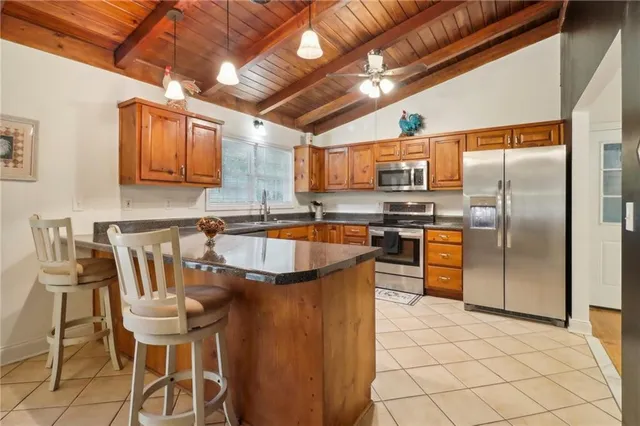 a kitchen with stainless steel appliances granite countertop a sink and a refrigerator