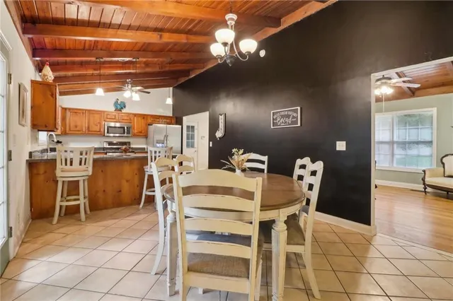 a dining room with furniture and a kitchen view