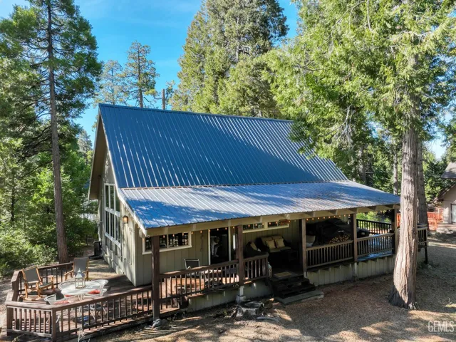 a view of a house with a bed and wooden floor