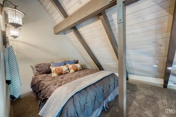 a bed sitting in a bedroom next to a window