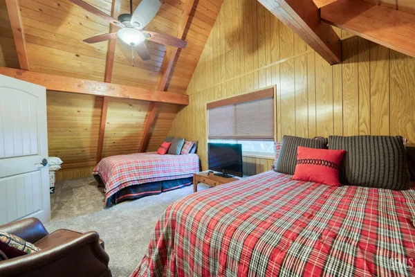 a bedroom with two beds and painted walls