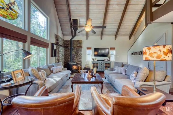 a living room with furniture a fireplace and a large window