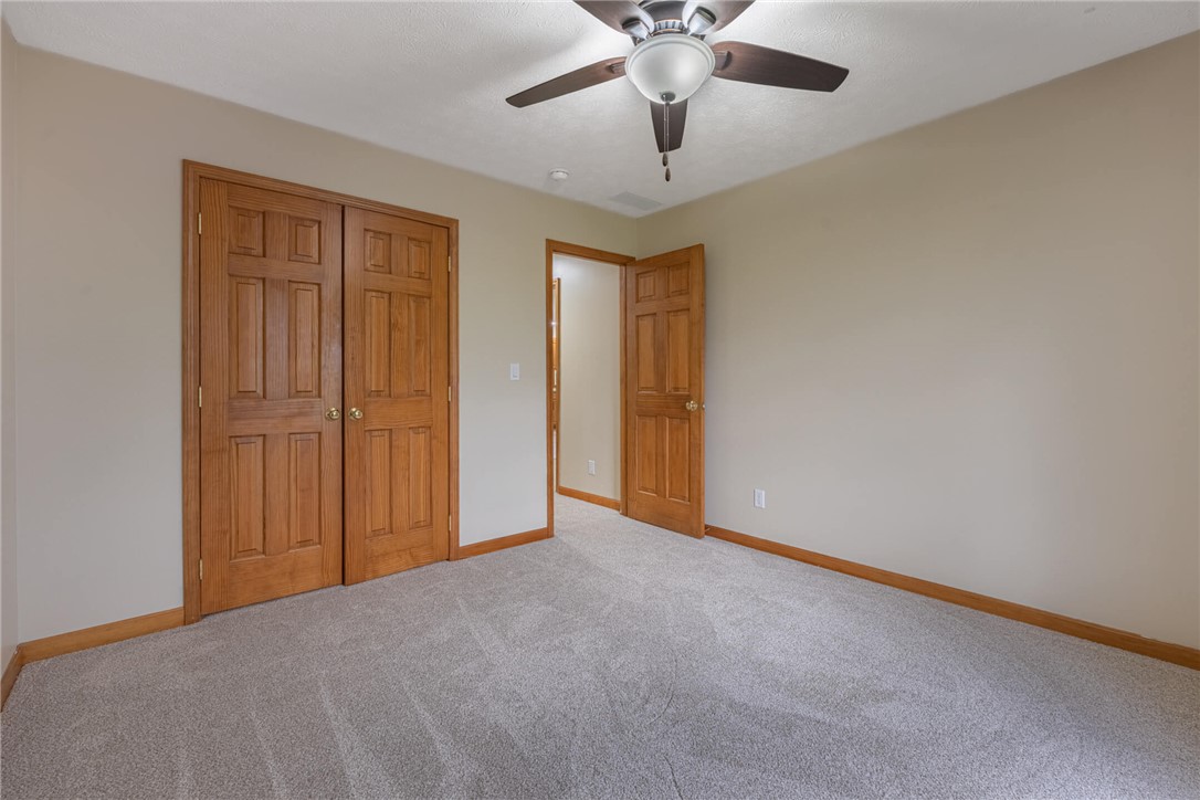 2645 Vance Road St. Paris, OH 43072 - Photo 18 of 35 A spacious sleeping area with neutral walls features twin closet doors and a ceiling fan for comfort.