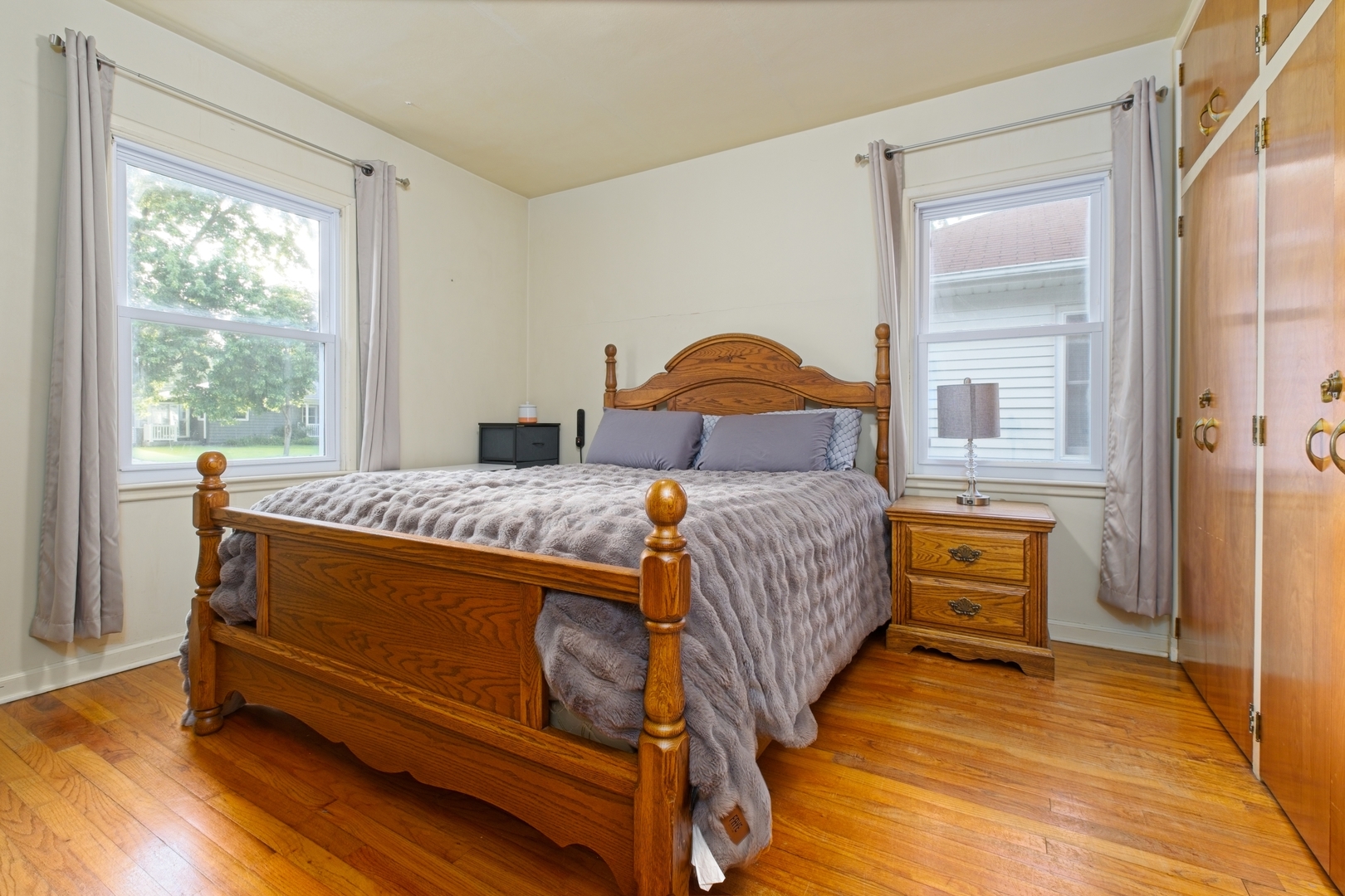 1019 North 3rd Street Clinton, IA 52732 - Photo 11 of 17 a bedroom with a bed and wooden floor