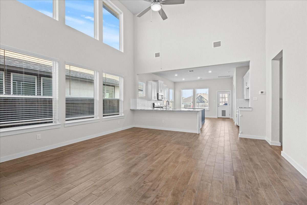 1027 Haystack New Braunfels, TX 78130 - Photo 4 of 15 a view of an empty room with wooden floor and a window