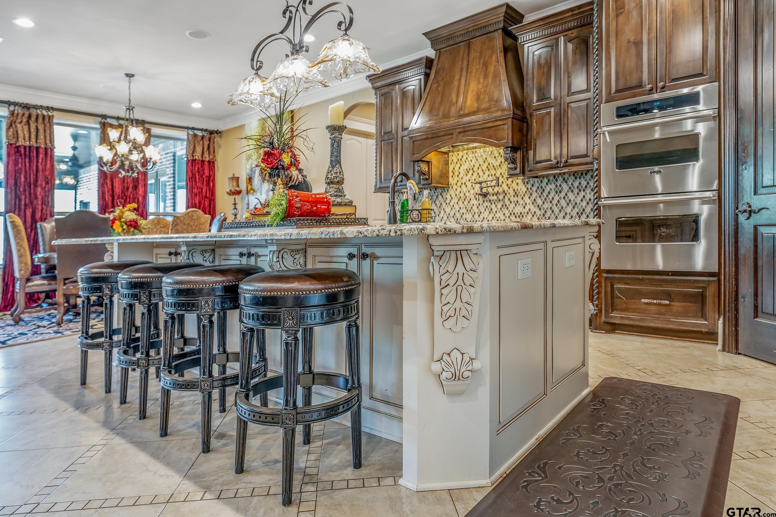 17521 Biltmore Circle Tyler, TX 75703 - Photo 11 of 48 a kitchen with stainless steel appliances granite countertop a stove and cabinets