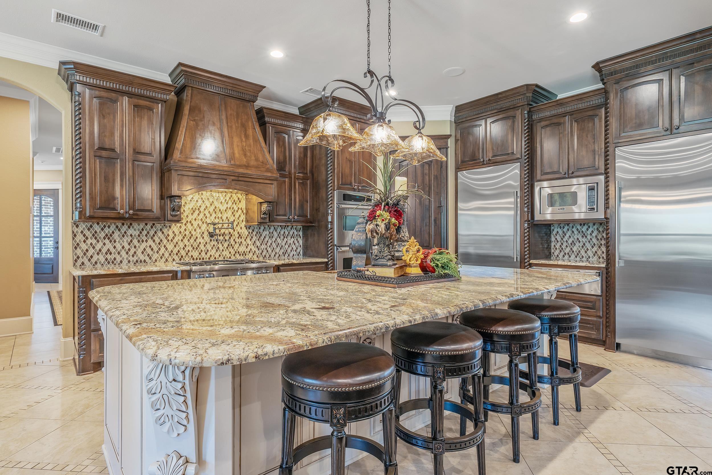 17521 Biltmore Circle Tyler, TX 75703 - Photo 12 of 48 a kitchen with granite countertop a table and chairs in it