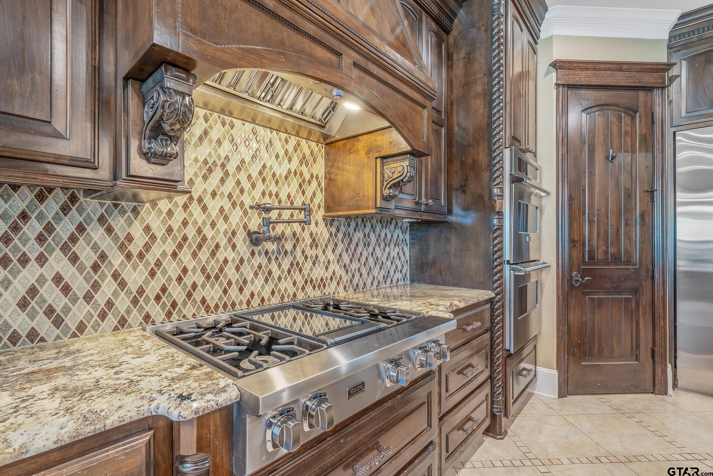17521 Biltmore Circle Tyler, TX 75703 - Photo 16 of 48 a stove top oven sitting inside of a kitchen