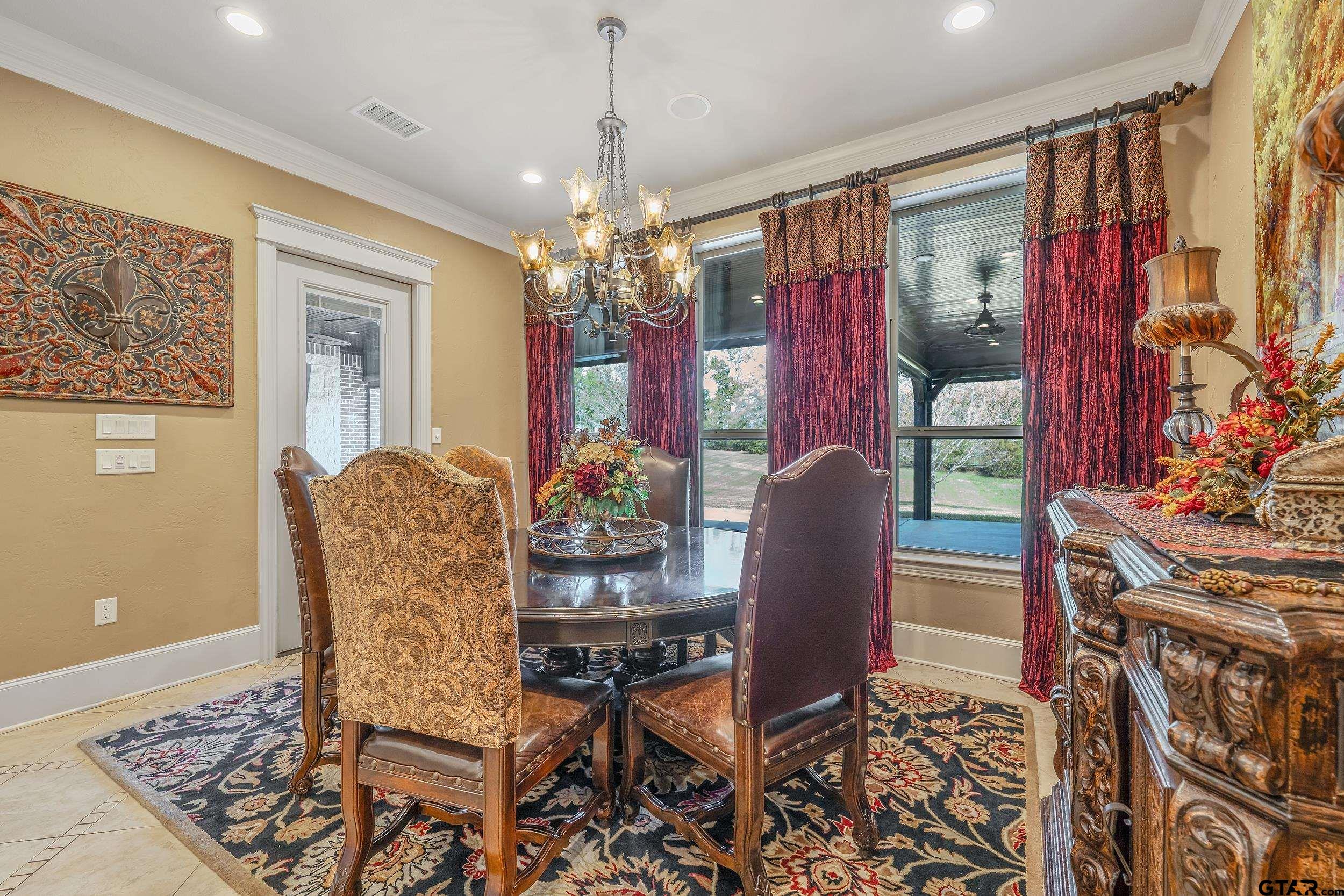 17521 Biltmore Circle Tyler, TX 75703 - Photo 17 of 48 a view of a dining room with furniture and chandelier