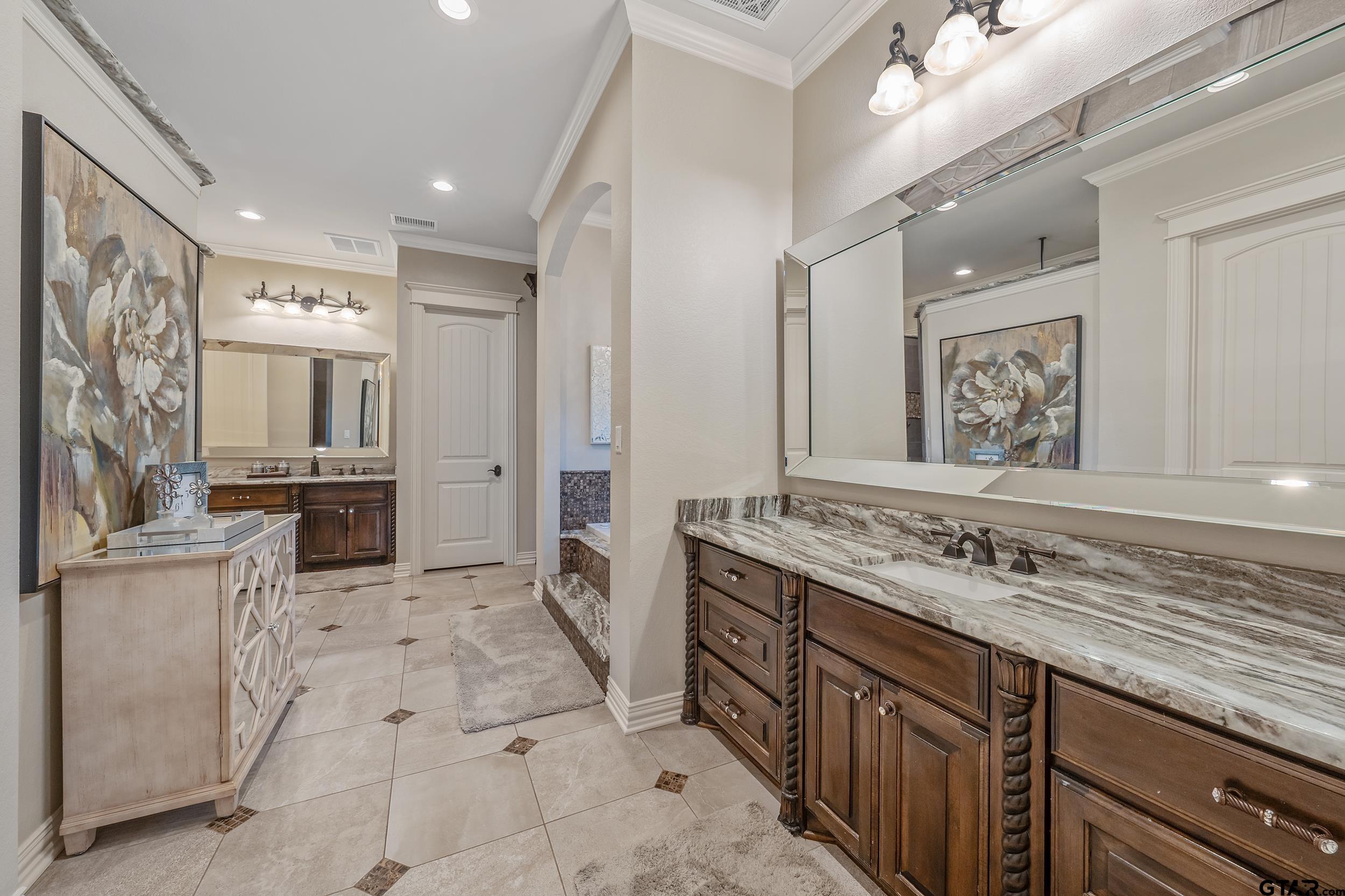 17521 Biltmore Circle Tyler, TX 75703 - Photo 21 of 48 a spacious bathroom with a granite countertop double vanity sink a mirror and a shower