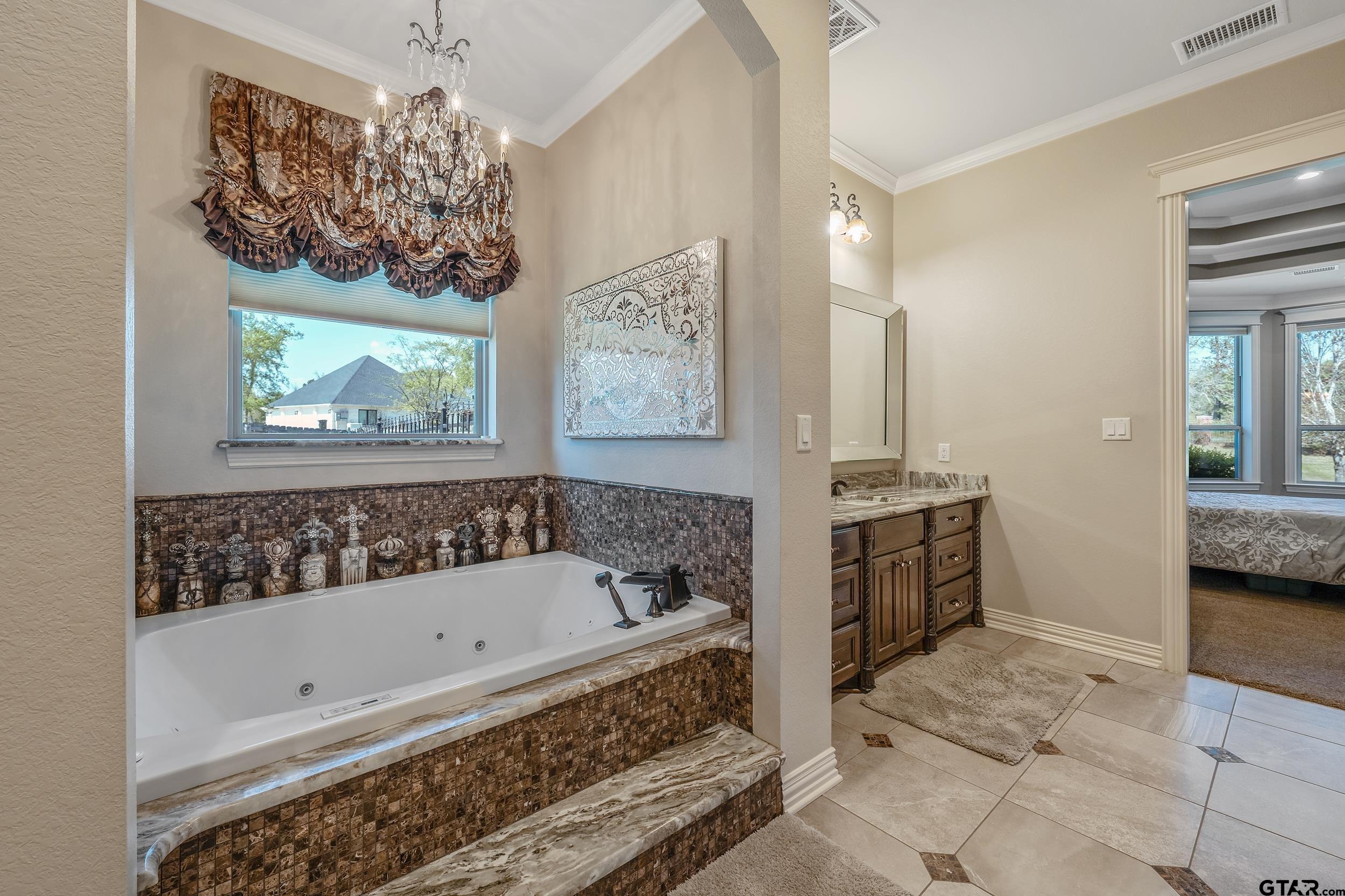 17521 Biltmore Circle Tyler, TX 75703 - Photo 22 of 48 a bathroom with a bathtub and a shower