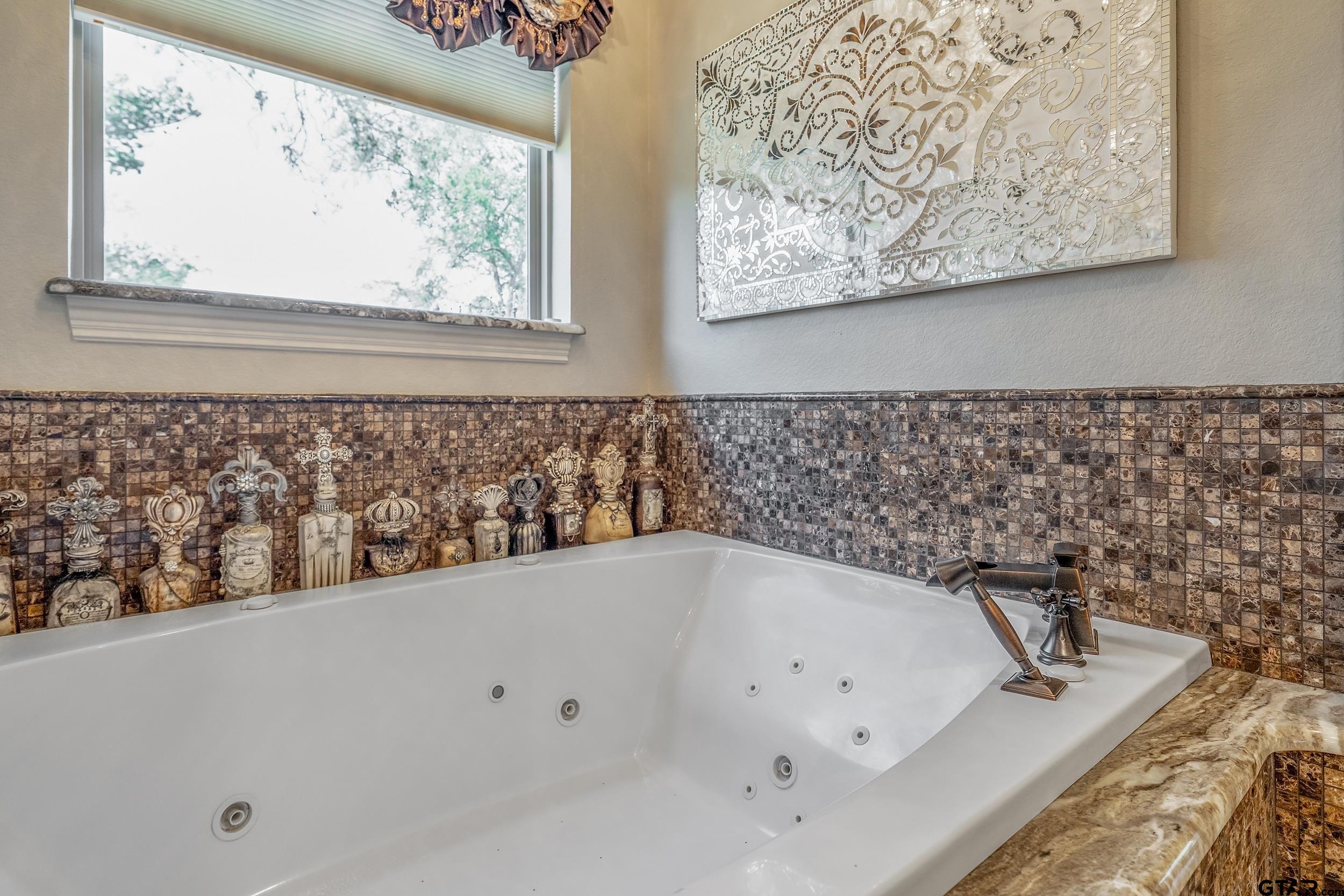 17521 Biltmore Circle Tyler, TX 75703 - Photo 23 of 48 a bathroom with a bathtub and a shower