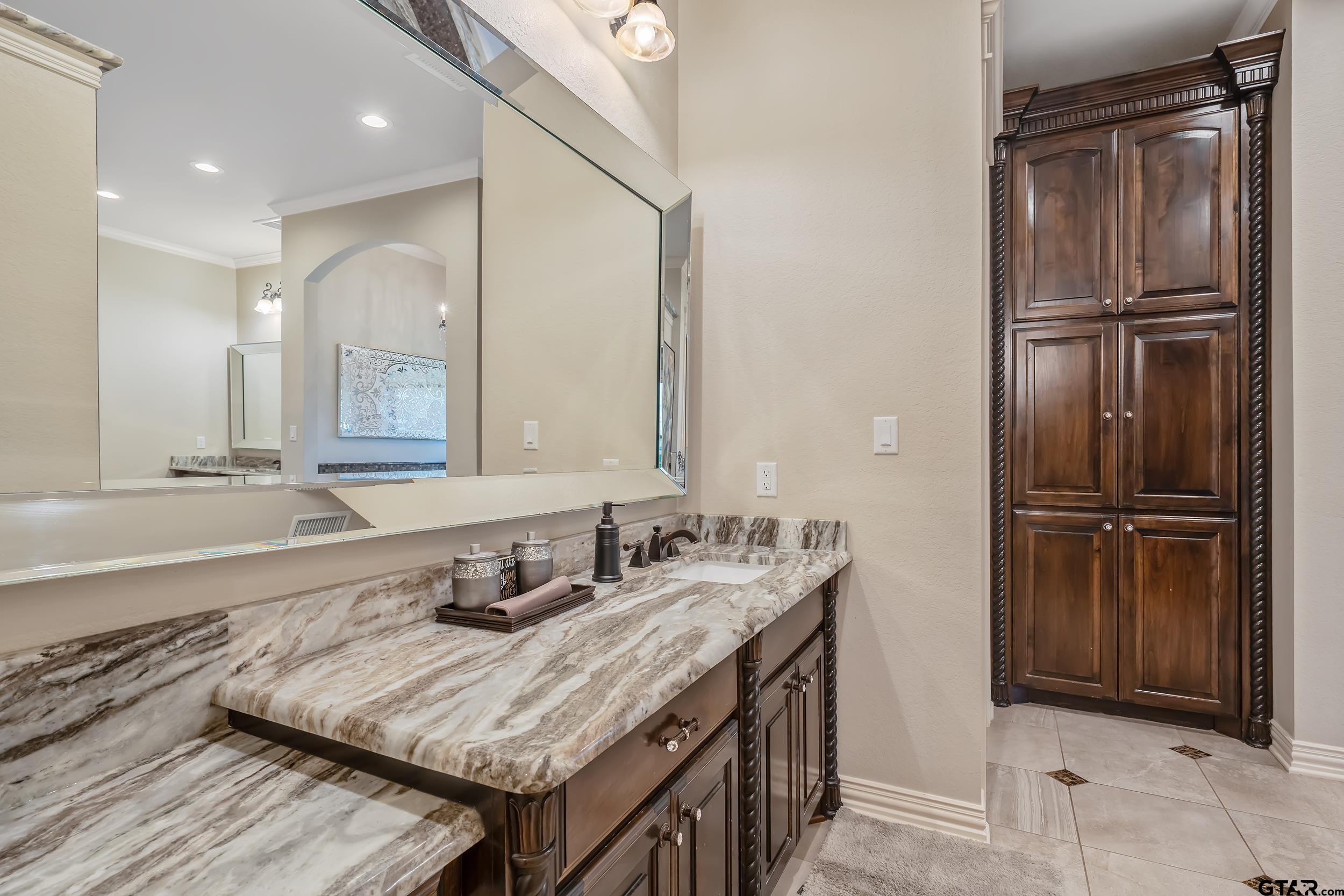 17521 Biltmore Circle Tyler, TX 75703 - Photo 28 of 48 a bathroom with a granite countertop sink and a mirror