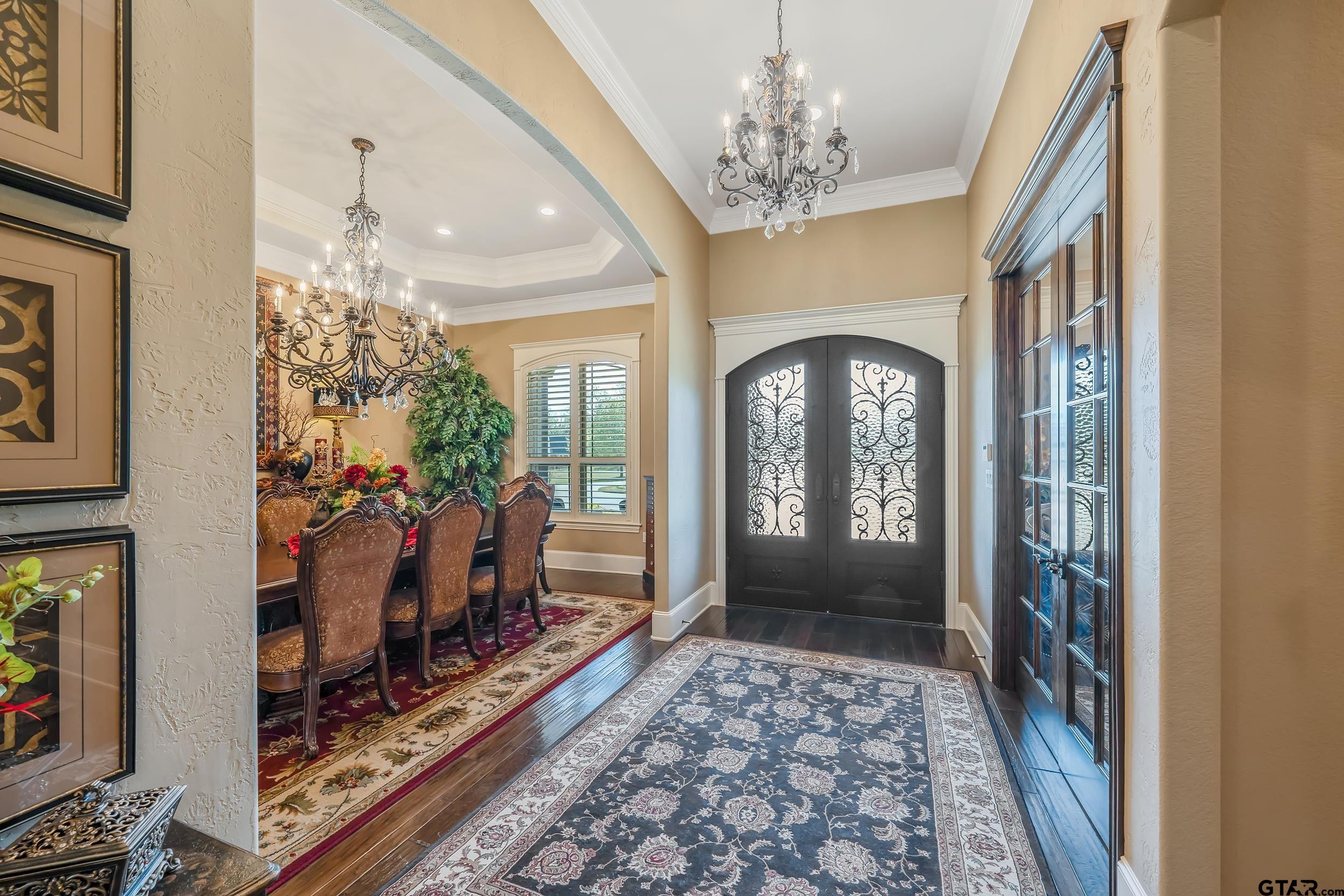 17521 Biltmore Circle Tyler, TX 75703 - Photo 6 of 48 a view of a hallway with wooden floor and a chandelier