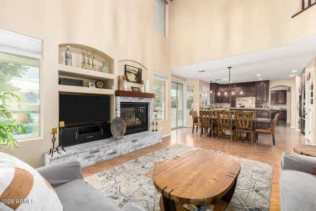 a dining room with wooden floor and large window