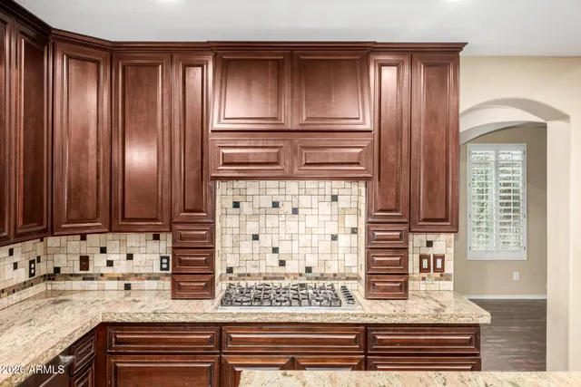 a kitchen with kitchen island a sink stove and refrigerator