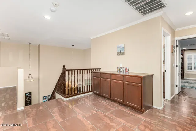 a view of a hallway with wooden floor and a livingroom