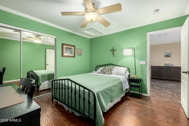 a bedroom with a bed and painting on the wall