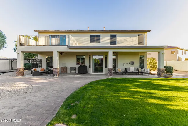 a view of a house with backyard porch and sitting area
