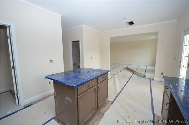 a view of kitchen island with furniture and wooden floor