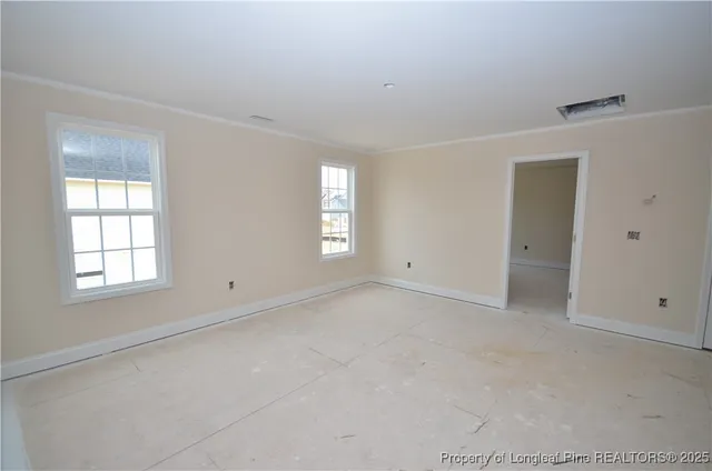 an empty room with windows and closet
