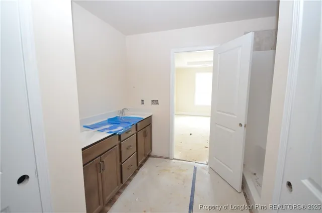 a kitchen with white cabinets and a sink