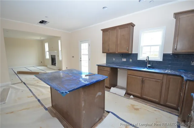 a kitchen with sink cabinets and window