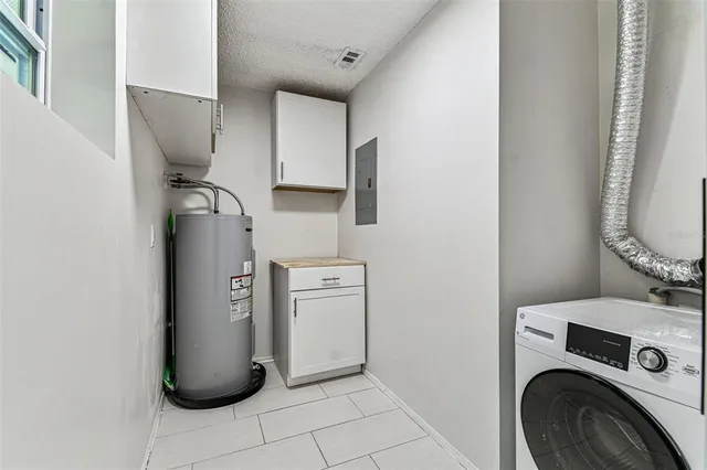 a view of a storage and utility room with washer and dryer