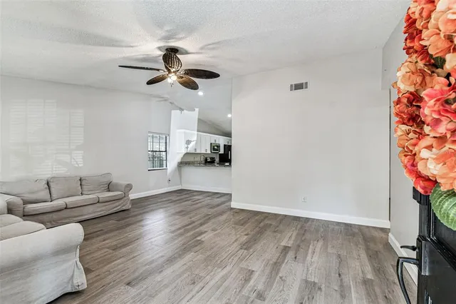 a living room with furniture and a potted plant