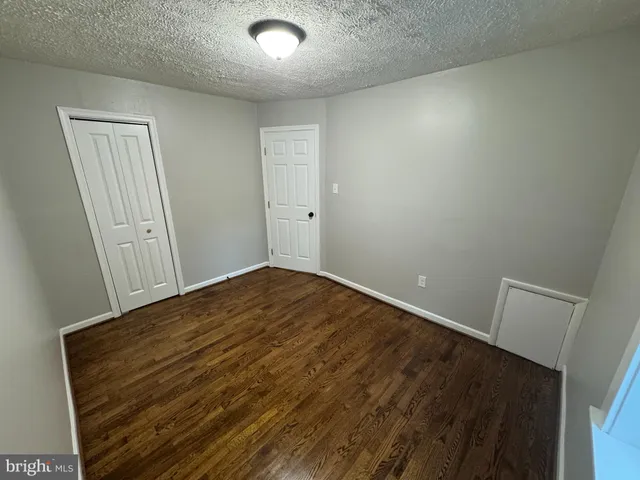 an empty room with wooden floor