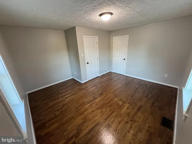 an empty room with wooden floor