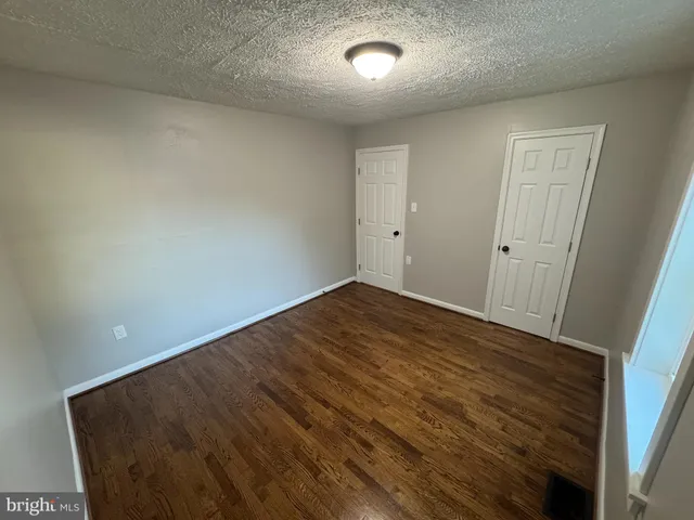 an empty room with wooden floor