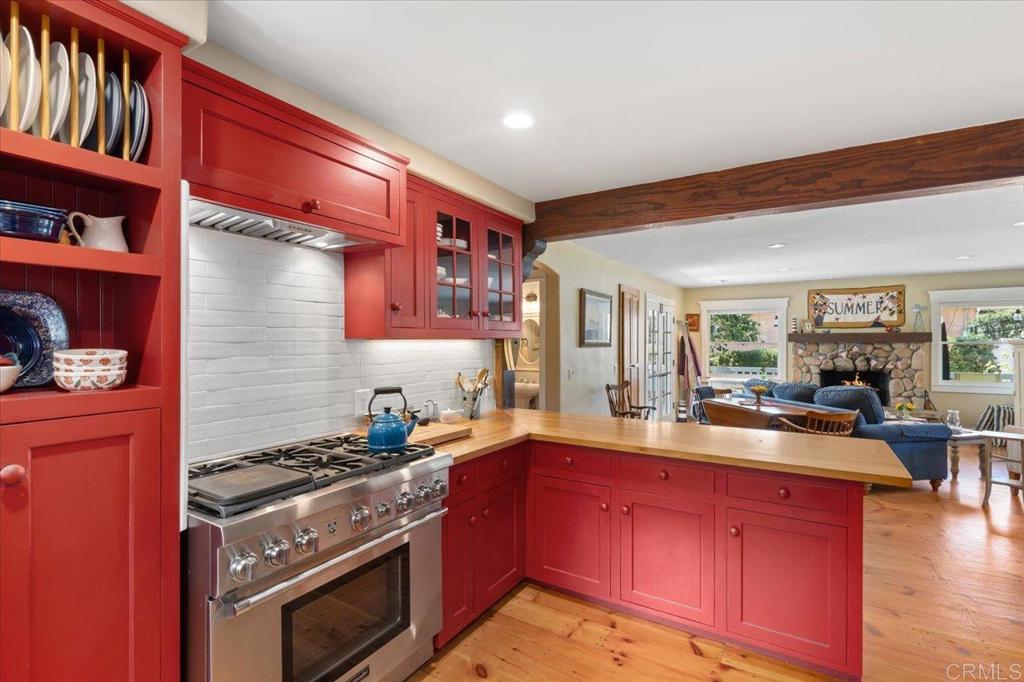 845 Crescent Drive Vista, CA 92084 - Photo 7 of 22 a kitchen with stainless steel appliances granite countertop a stove and a wooden cabinets