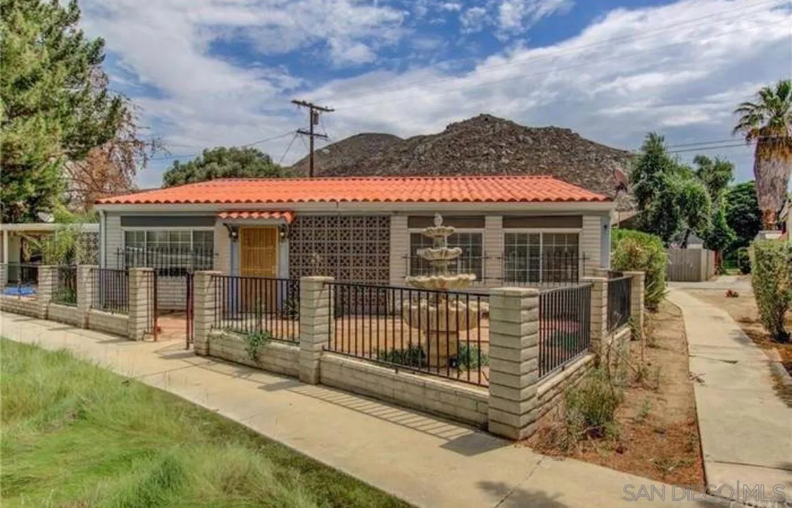 a view of a house with a wooden fence