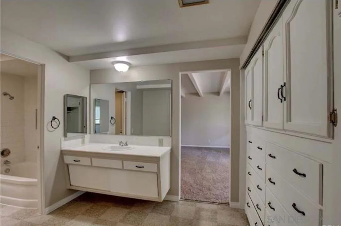 632 Gibbel Road Hemet, CA 92543 - Photo 8 of 11 a bathroom with a double vanity sink a mirror a bathtub and