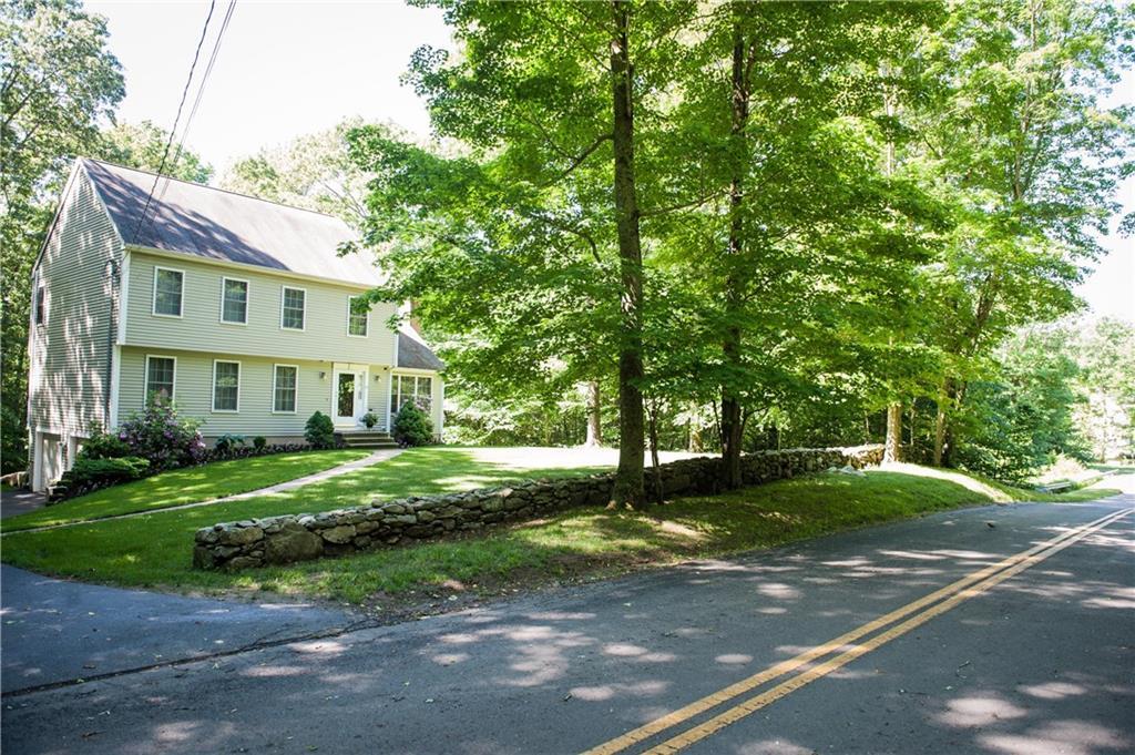 25 Ben Merrill Road Clinton, CT 06413 - Photo 1 of 1 a view of a white house next to a yard with big trees