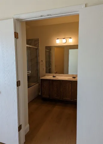 a bathroom with a double vanity sink and mirror