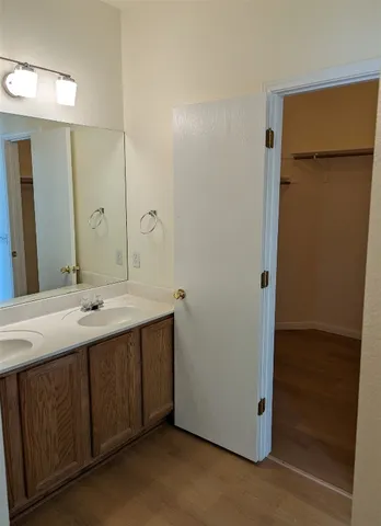 a bathroom with a double vanity sink and mirror
