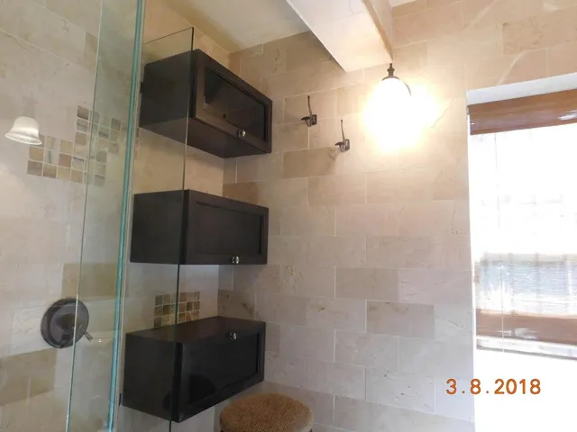 a bathroom with a shower and a sink