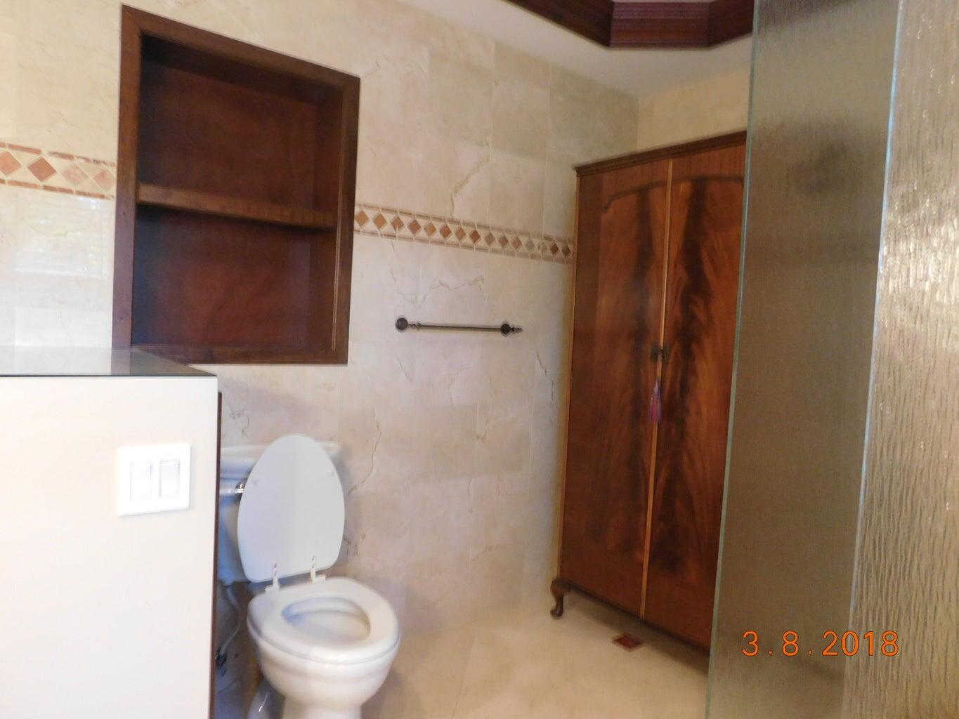 6608 Southwest 65th Street South Miami, FL 33143 - Photo 17 of 25 a bathroom with a toilet a sink and mirror