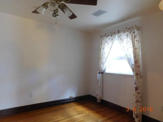 a room with a window and wooden floor